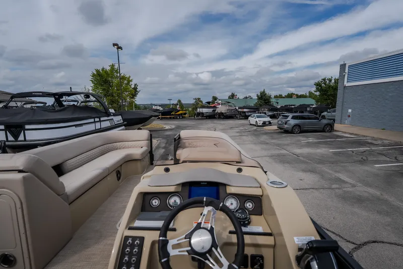 Slide: The Image of 2023 Crest Caribbean LX 250 boat interior at a marina parking lot. - 33