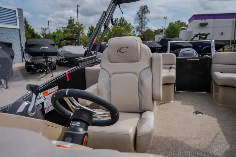 Slide: The Image of 2023 Crest Caribbean LX 250 boat interior with steering wheel and seating. - 55
