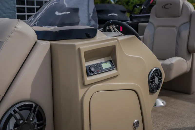 Slide: The Image of 2023 Crest Caribbean LX 250 boat dashboard with audio controls and speakers. - 48