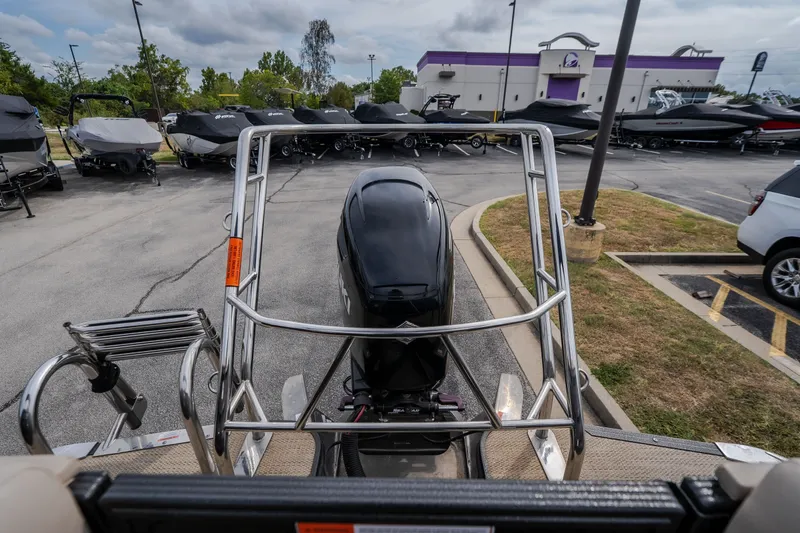 Slide: The Image of 2023 Crest Caribbean LX 250 boat with outboard motor in a dealership lot. - 29