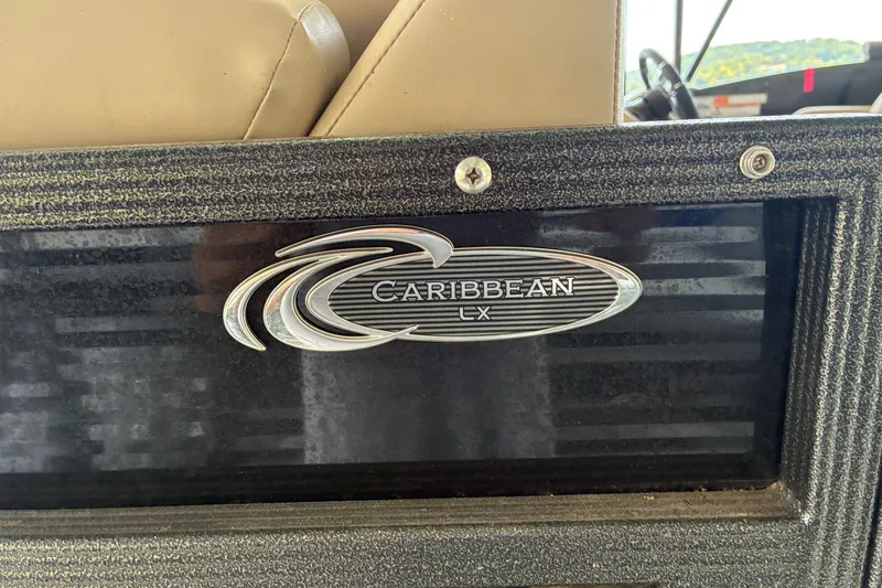 Slide: The Image of 2023 Crest Caribbean LX 250 logo on textured boat surface. - 12