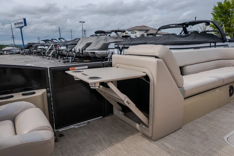 Slide: The Image of 2023 Crest Caribbean LX 250 boat interior with foldable table and seating. - 38