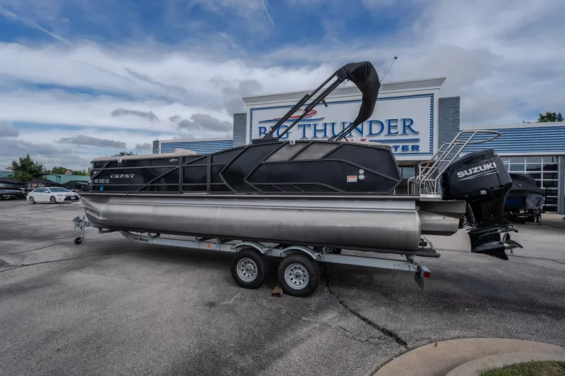 Slide: The Image of 2023 Crest Caribbean LX 250 pontoon boat on trailer at dealership. - 26