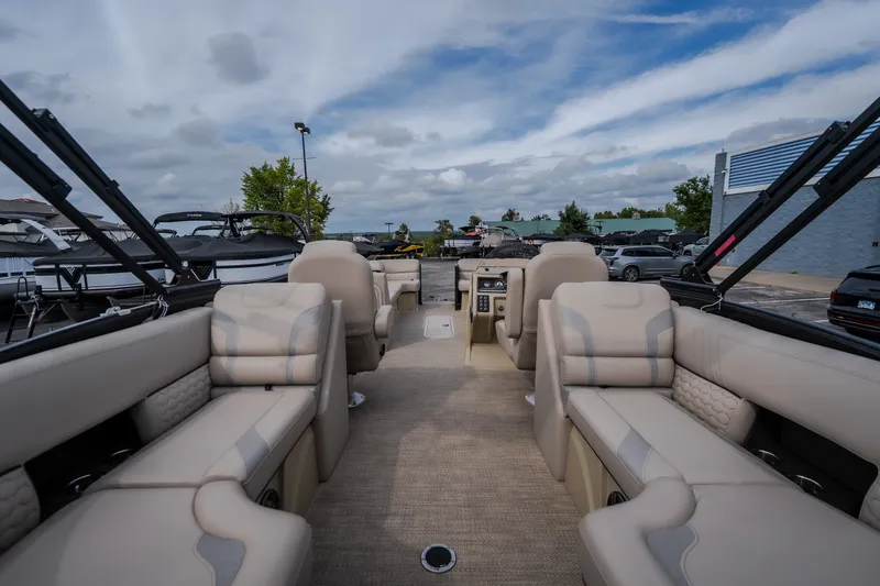 Slide: The Image of 2023 Crest Caribbean LX 250 pontoon boat interior with luxurious seating and open layout. - 31