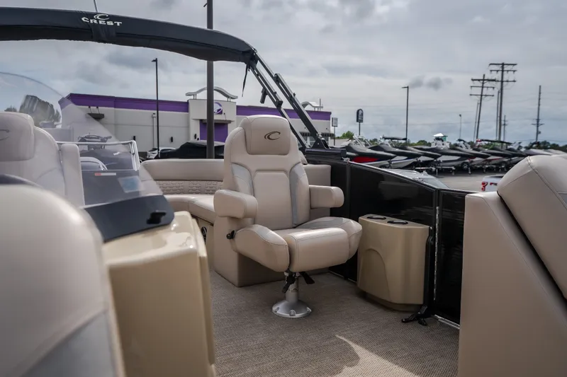 Slide: The Image of 2023 Crest Caribbean LX 250 boat interior with luxurious seating and cup holders. - 51