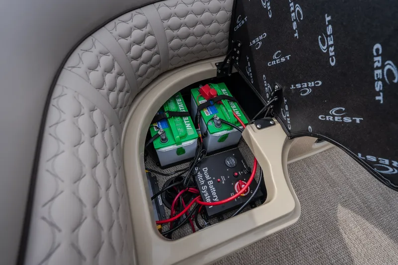 Slide: The Image of 2023 Crest Caribbean LX 250 battery compartment with dual battery switch system. - 40