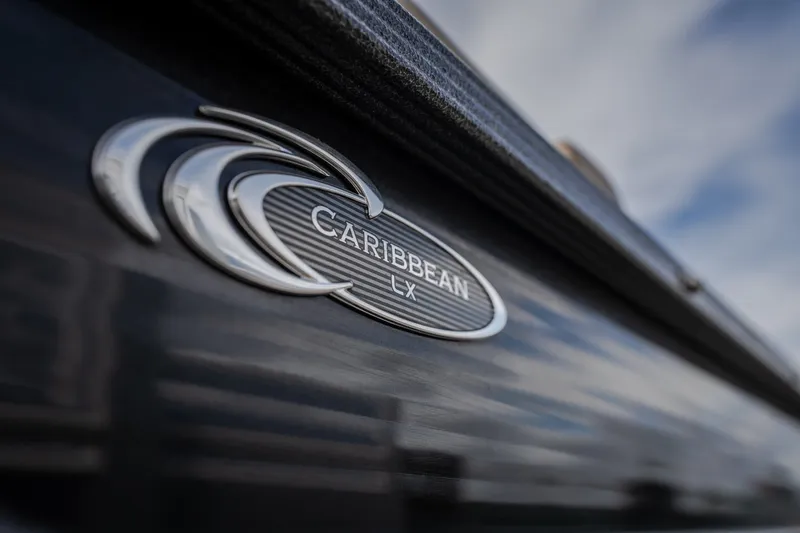Slide: The Image of 2023 Crest Caribbean LX 250 logo on sleek boat exterior. - 21