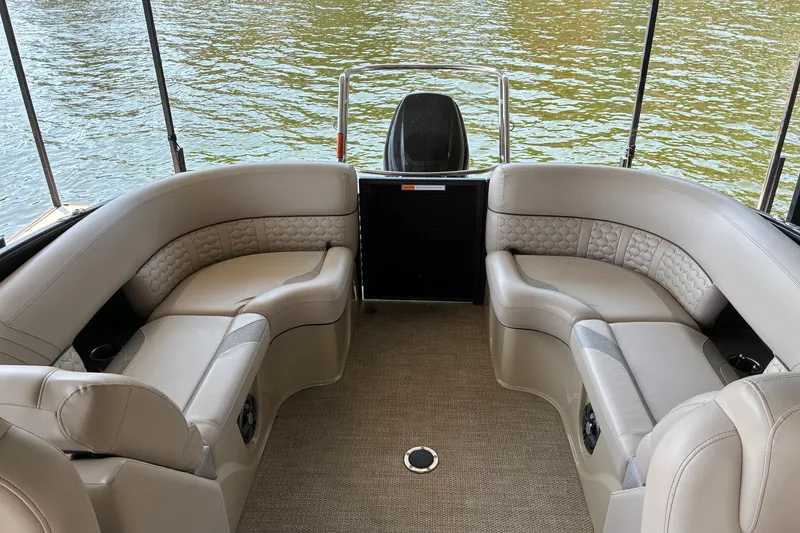 Slide: The Image of 2023 Crest Caribbean LX 250 boat interior with luxurious seating on a calm lake. - 15