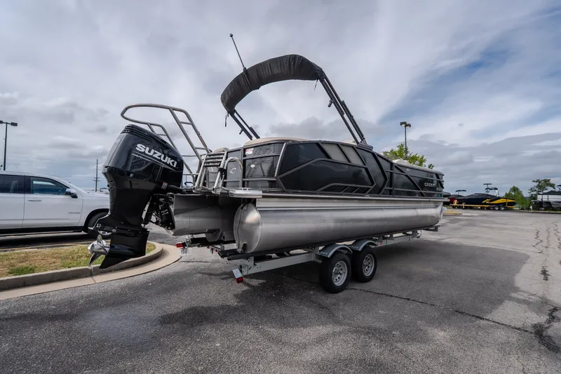 Slide: The Image of 2023 Crest Caribbean LX 250 pontoon boat on trailer with Suzuki outboard motor. - 22