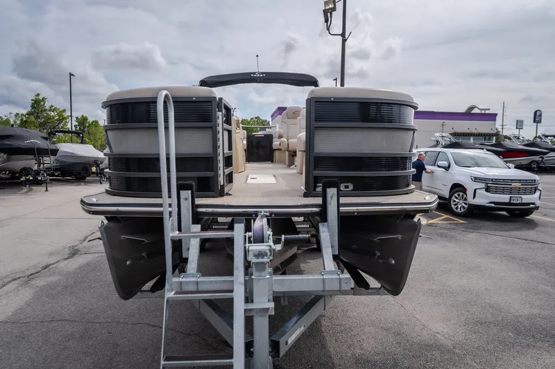 Slide: The Image of 2023 Crest Caribbean LX 250 pontoon boat on trailer in parking lot. - 19