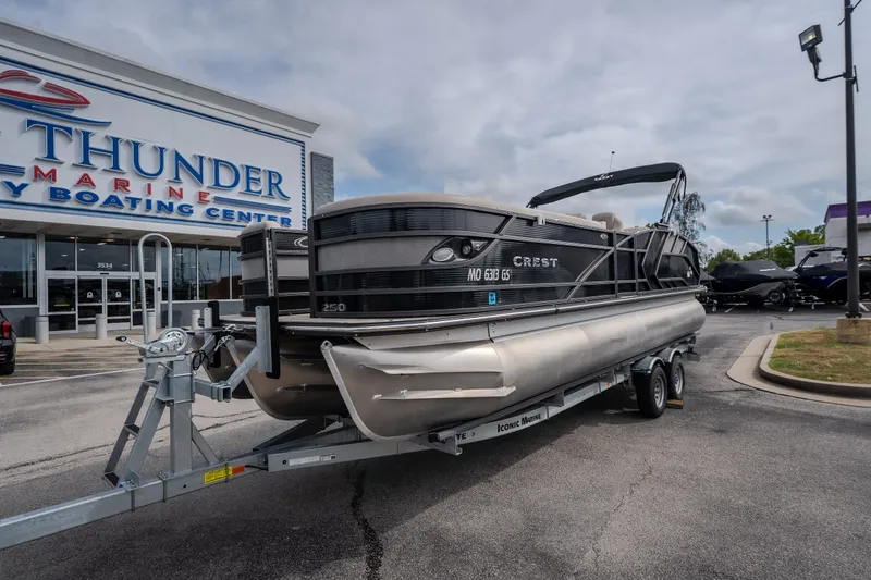 Slide: The Image of 2023 Crest Caribbean LX 250 pontoon boat on trailer at Thunder Marine Boating Center. - 16