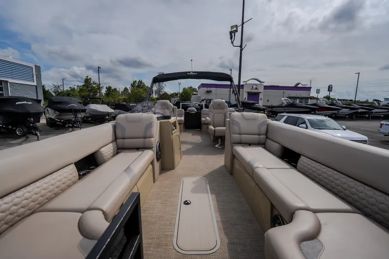 Slide: The Image of 2023 Crest Caribbean LX 250 pontoon boat interior with luxurious seating and modern design. - 43