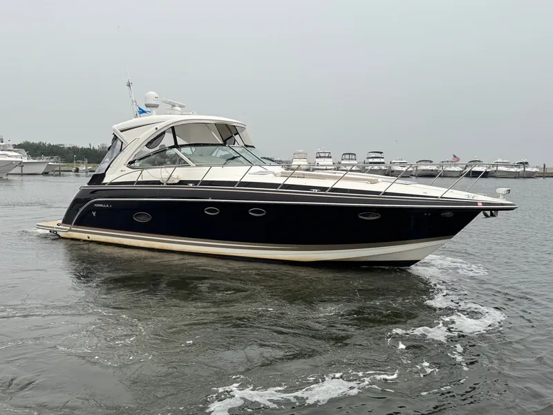 Slide: The Image of A black 2016 Formula 40 Performance Cruiser on the water, surrounded by other boats. - 1