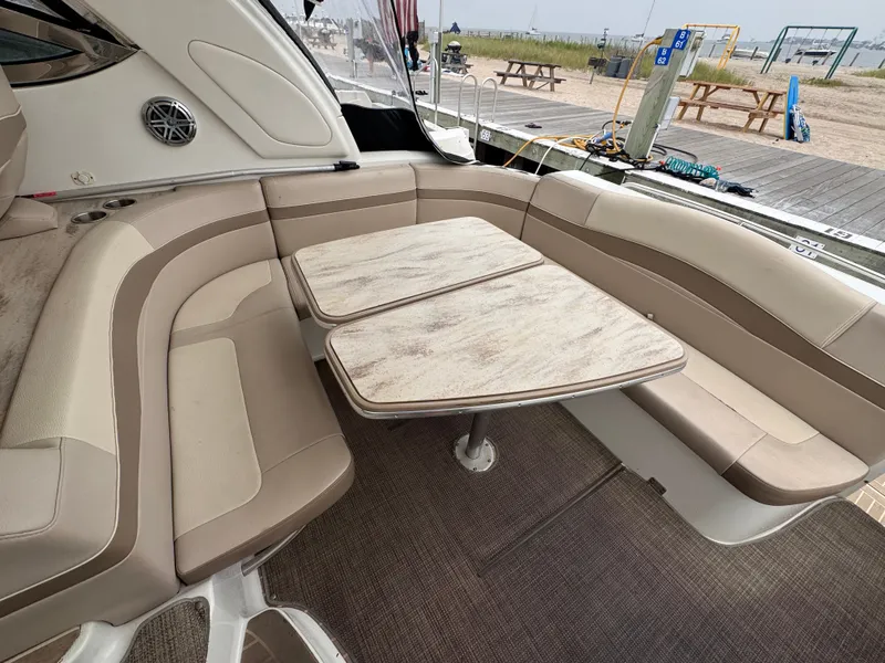 Slide: The Image of The image shows the seating area of a 2016 Formula 40 Performance Cruiser with beige upholstery and wooden tables. - 5