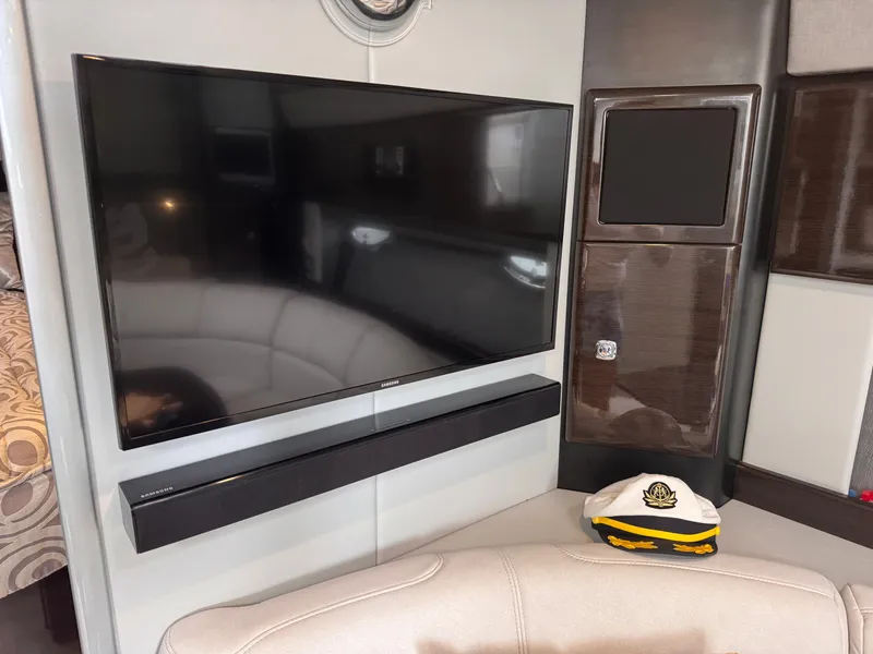 Slide: The Image of Interior of a yacht with a large flat-screen TV and a captain's hat on a seat. - 23