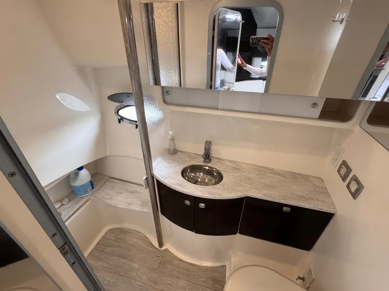 Slide: The Image of Interior of a modern boat cabin with a sink, mirror, and wood flooring. - 25