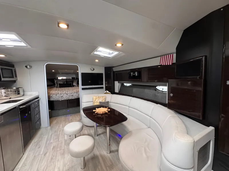 Slide: The Image of Interior of a luxury yacht with white sofa, wooden table, and modern kitchen. - 21