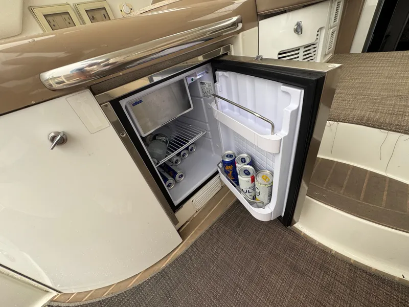 Slide: The Image of An open fridge on a boat with beverage cans inside. - 9