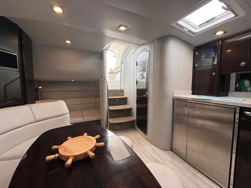 Slide: The Image of Interior of a luxury yacht with sleek kitchen, comfortable seating area, and stylish wood accents. - 27