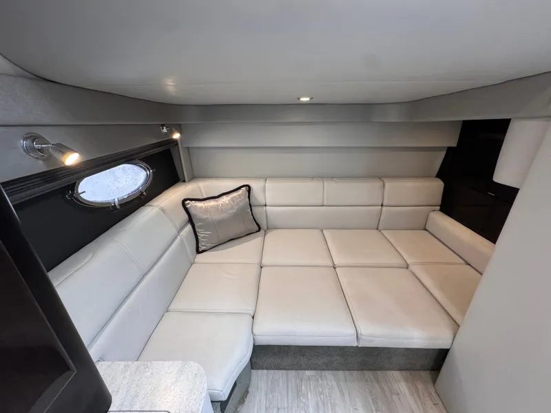 Slide: The Image of Interior of a 2016 Formula 40 Performance Cruiser with beige L-shaped sofa and porthole. - 20