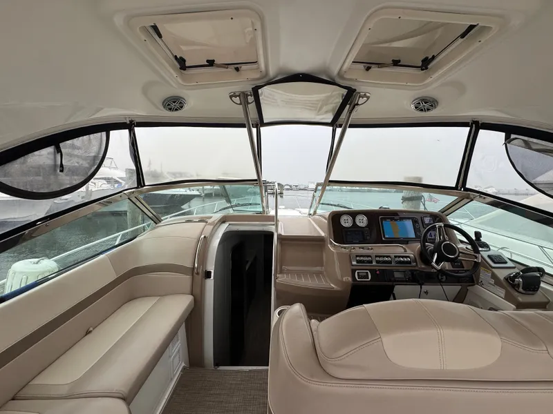 Slide: The Image of The cockpit of the 2016 Formula 40 Performance Cruiser features sleek design with beige seating and modern electronics. - 7