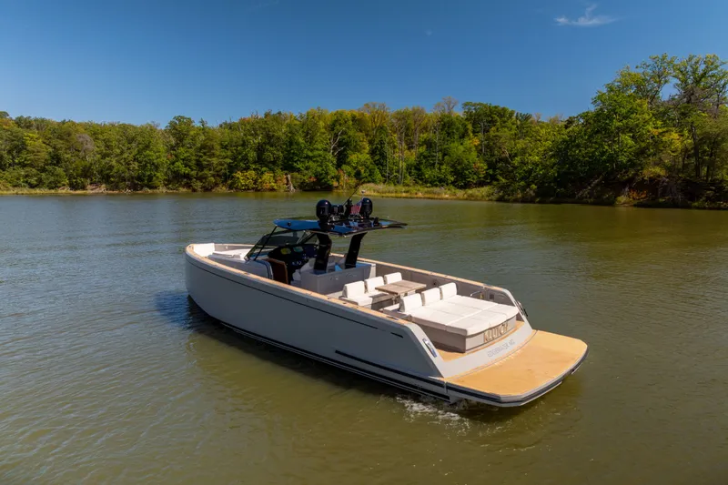 Slide: The Image of 2023 Pardo Yachts 43 cruising on a serene lake with lush green surroundings. - 11
