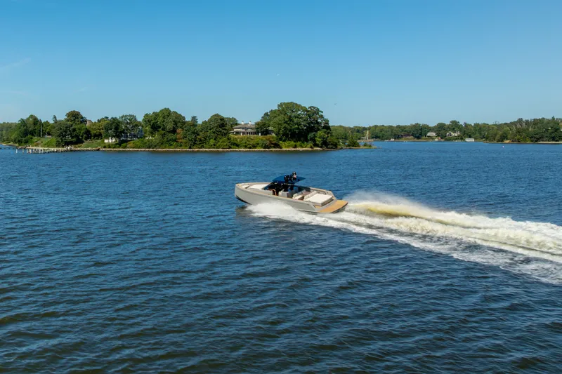 Slide: The Image of 2023 Pardo Yachts 43 cruising on a scenic lake under a clear blue sky. - 67
