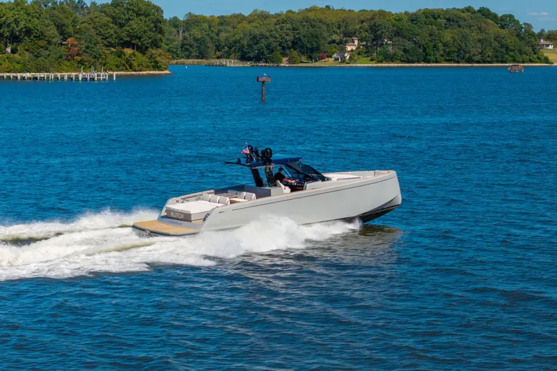 Slide: The Image of 2023 Pardo Yachts 43 cruising on a scenic blue lake with lush green shoreline. - 69