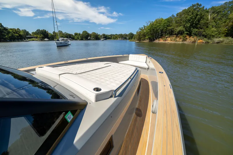 Slide: The Image of 2023 Pardo Yachts 43 cruising on a serene river with lush greenery. - 24