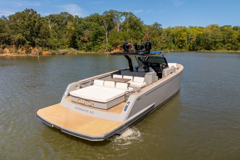 Slide: The Image of 2023 Pardo Yachts 43 cruising on a serene lake with lush green surroundings. - 15