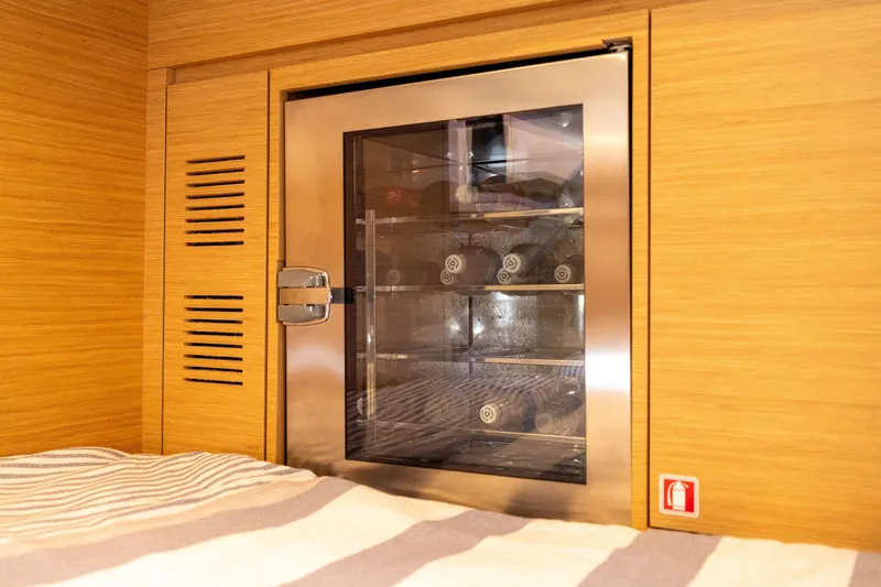 Slide: The Image of Built-in wine cooler on 2023 Pardo Yachts 43, featuring sleek wooden cabinetry. - 59