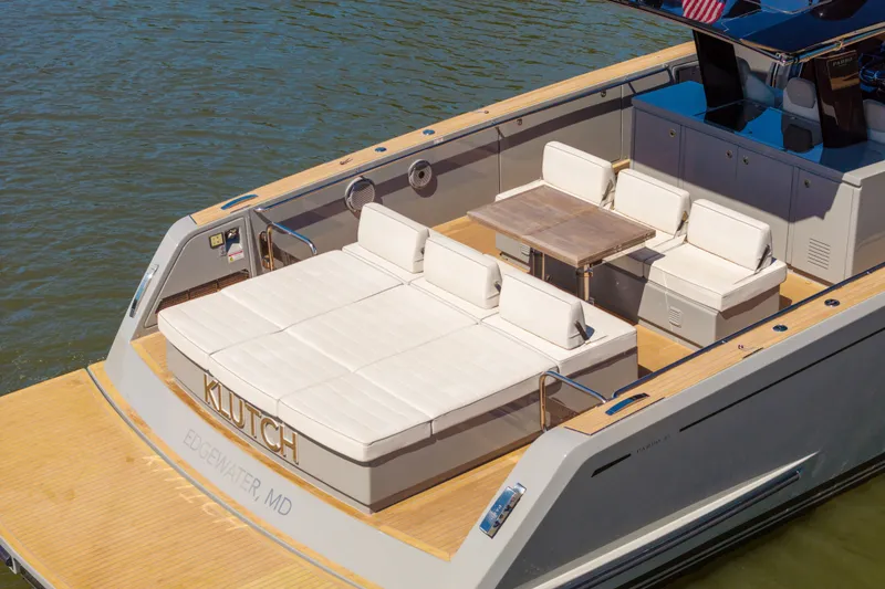 Slide: The Image of Luxurious 2023 Pardo Yachts 43 with elegant deck seating and table on calm waters. - 17