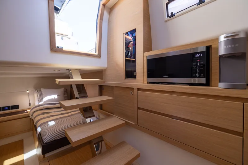 Slide: The Image of Interior of 2023 Pardo Yachts 43 with modern kitchen and cozy sleeping area. - 54