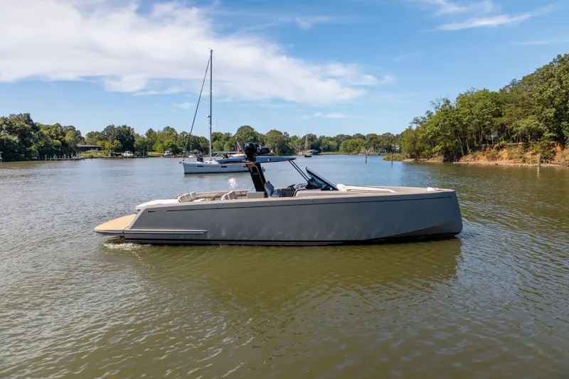 Slide: The Image of 2023 Pardo Yachts 43 cruising on a serene lake under a clear blue sky. - 65