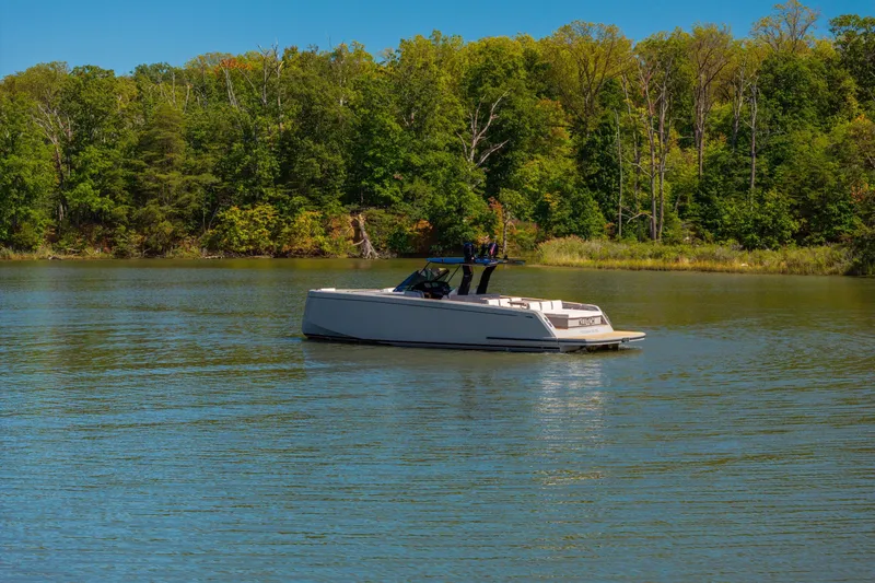 Slide: The Image of 2023 Pardo Yachts 43 cruising on a serene lake surrounded by lush greenery. - 66