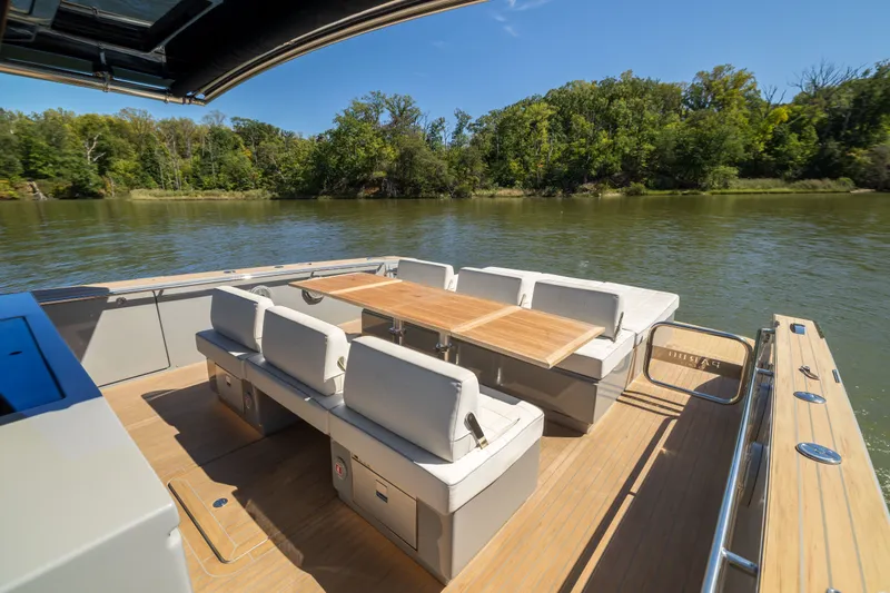 Slide: The Image of Luxurious 2023 Pardo Yachts 43 with elegant outdoor seating on a serene river. - 43