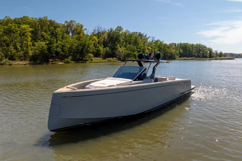 Slide: The Image of 2023 Pardo Yachts 43 cruising on a serene lake with lush green trees. - 10