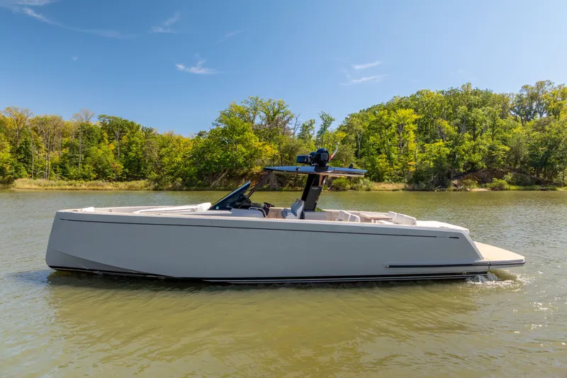 Slide: The Image of 2023 Pardo Yachts 43 cruising on a serene lake with lush green trees. - 9