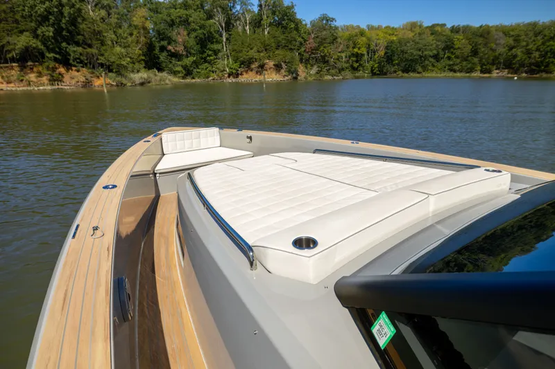 Slide: The Image of 2023 Pardo Yachts 43 luxury yacht with sleek deck and comfortable seating on a serene lake. - 23