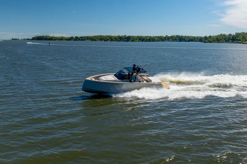 Slide: The Image of 2023 Pardo Yachts 43 cruising on a sunny lake with lush green shoreline. - 73