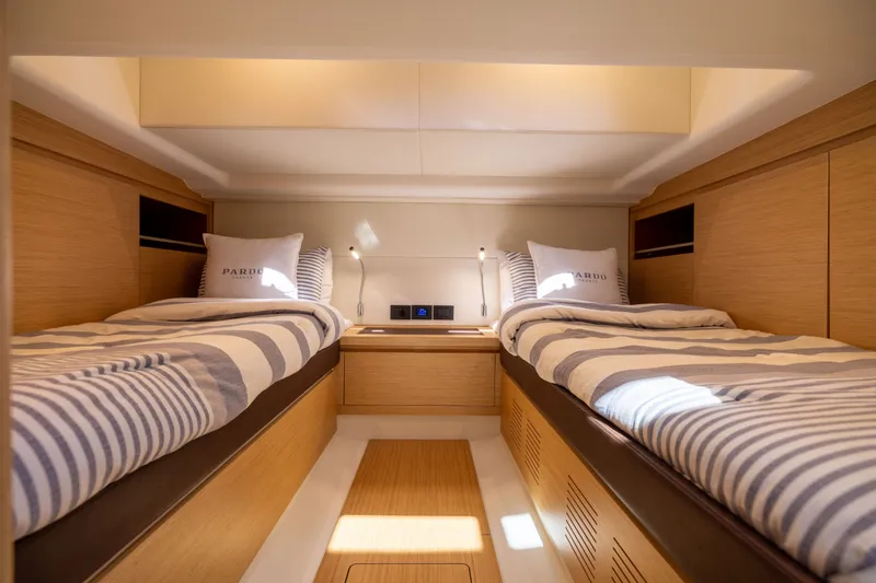 Slide: The Image of Luxurious twin cabin interior of 2023 Pardo Yachts 43 with striped bedding. - 55