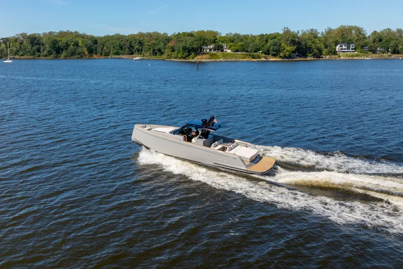 Slide: The Image of 2023 Pardo Yachts 43 cruising on a serene lake with lush green shoreline. - 71