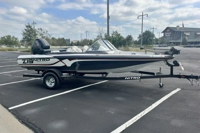 Slide: The Image of 2021 Nitro Z19 boat on trailer in parking lot under cloudy sky. - 11