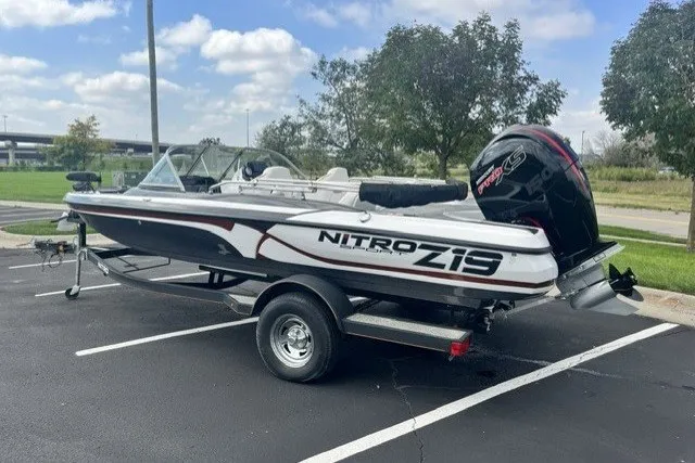 Slide: The Image of 2021 Nitro Z19 boat on trailer in parking lot, under blue sky. - 3