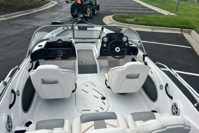Slide: The Image of Interior view of a 2021 Nitro Z19 boat with white seating and dashboard. - 5