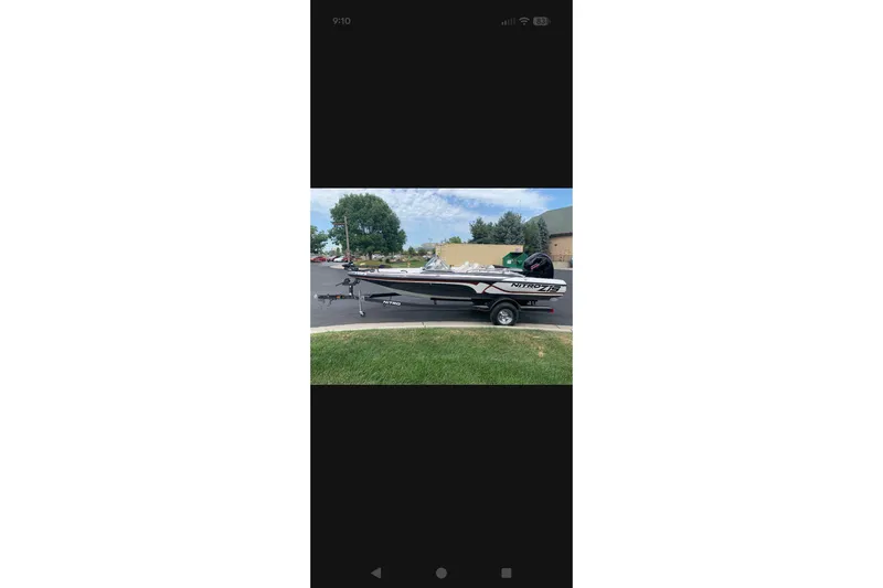 Slide: The Image of 2021 Nitro Z19 boat on trailer, parked outdoors. - 2