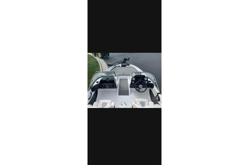 Slide: The Image of 2021 Nitro Z19 boat cockpit with steering wheel and dashboard controls. - 7