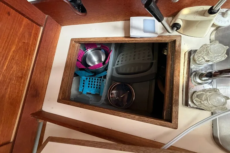 Slide: The Image of Interior of 1980 Tartan 33 sailboat showing storage compartment with kitchen items. - 32