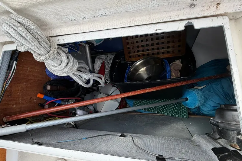 Slide: The Image of Storage compartment of a 1980 Tartan 33 sailboat, filled with nautical gear and ropes. - 27