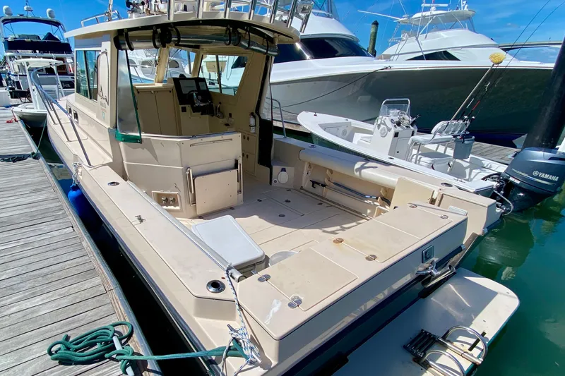 Slide: The Image of 2008 Albin 28 Tournament Express boat docked at marina, featuring spacious deck and modern design. - 4